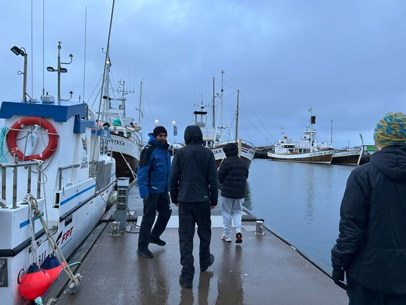 Daniel showing the students our boats