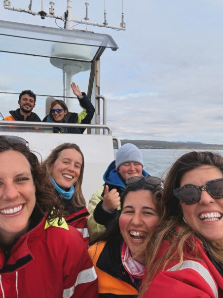 happy crew enjoying solar eclipse on board on whale watching tour